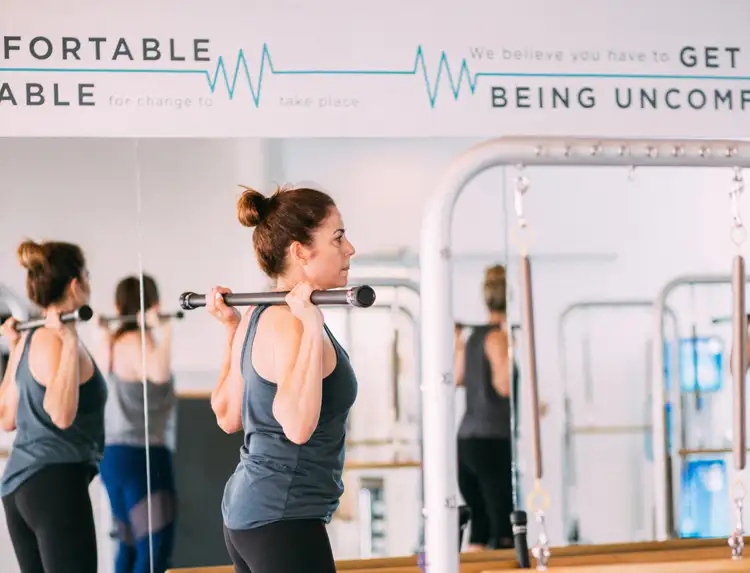 bodybar pilates woman working out with bar