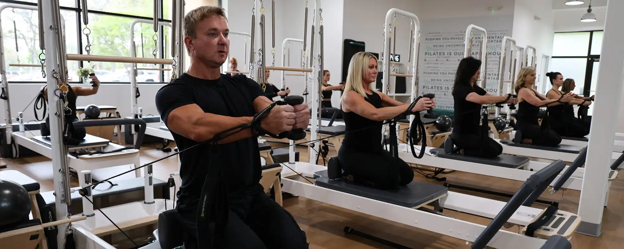 man and woman on reformer