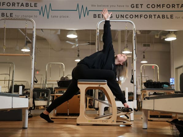 BODYBAR Pilates student stretching