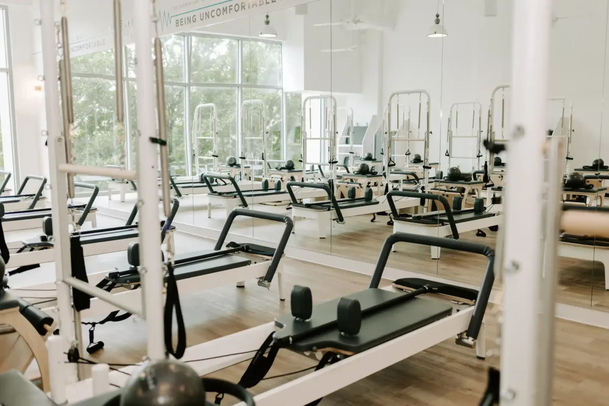 bodybar pilates studio reformers in front of studio mirror