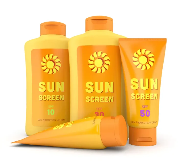 Four yellow and orange sunscreen bottles with SPF 10, 30, and 50 labels, arranged together on a white background.